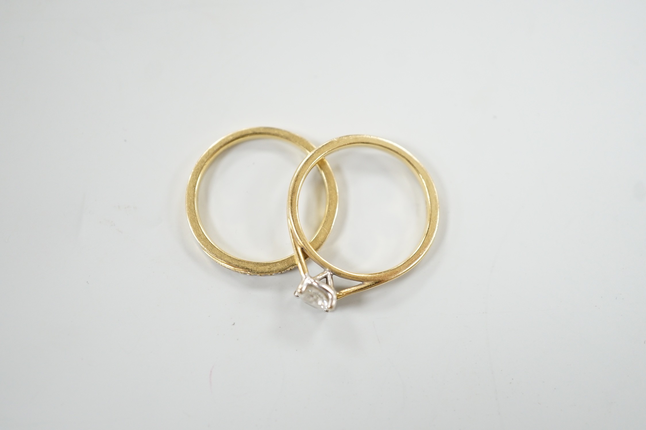 A modern Parkhouse 18ct gold wedding set, comprising a graduated ten stone diamond chip set half hoop band and an Isabella solitaire diamond ring, the latter with accompanying GIA report dated 4/12/2014, stating the ston